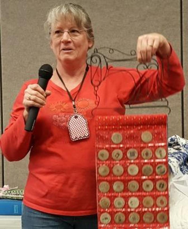 Carol made a wall hanging to display all of her 31 wooden nickels, from shop hop, and she won the  the Feather weight sewing machine!